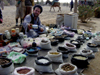 Sidewalk Salesman with Spices and Stones